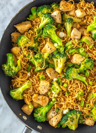 A close-up of a skillet filled with chicken ramen stir fry.