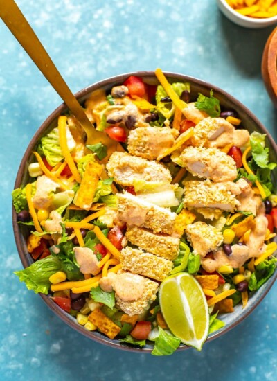 A close-up of a bowl of Copycat McDonald's Southwest Salad with a fork in it.