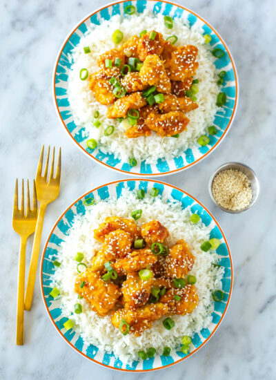 Two plates of copycat Panda Express orange chicken.