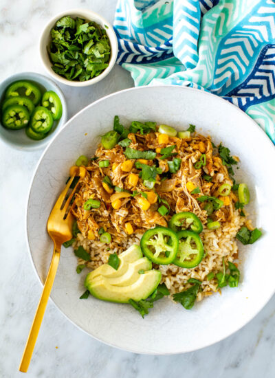 A bowl of salsa verde chicken served over rice.